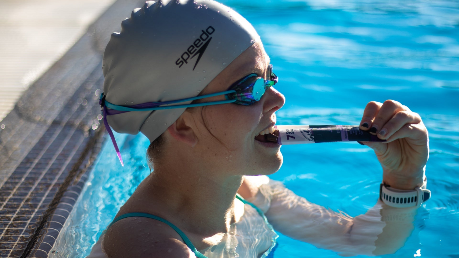 A swimmer in the pool having a superfood chocolate energy bar by 7 Summits Snacks to fuel their workout.